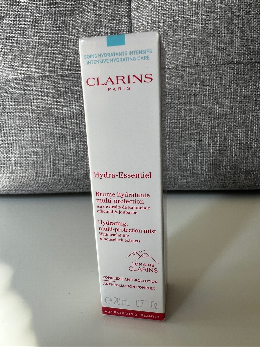 Clarins Hydra-Essentiel Hydrating Multi-Protection Mist — White with Red Accents